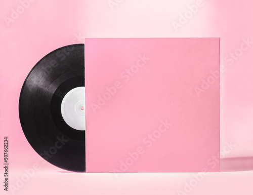 Vinyl music disc with blank pink cover isolated on pink background