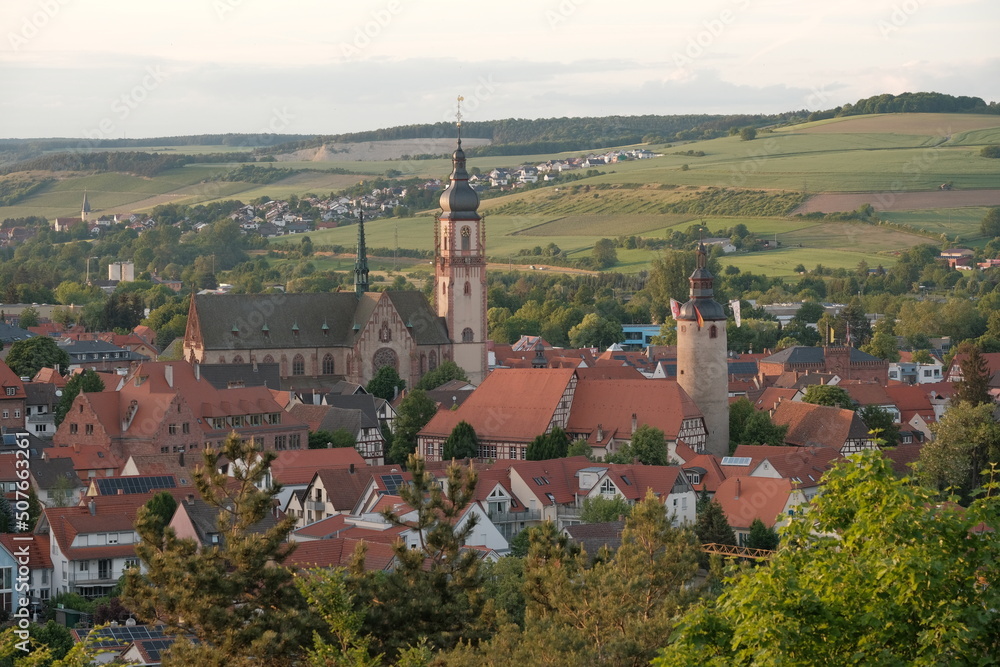Fototapeta premium View to the German city Tauberbischofsheim at sunset with church and tower in the city center.