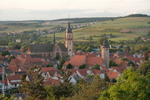 View to the German city Tauberbischofsheim at sunset with church and tower in the city center.