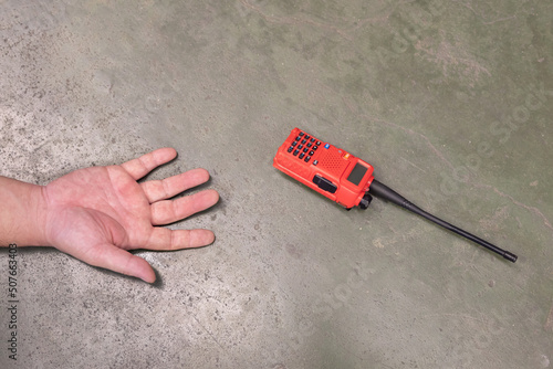 Unconscious Man Hand Falling on the Factory Floor with his Walkie Talkie