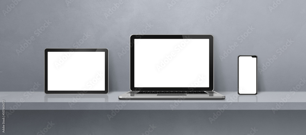 Laptop, mobile phone and digital tablet pc on grey wall shelf. Banner background Laptop, mobile phone and digital tablet pc on grey wall shelf. Banner background