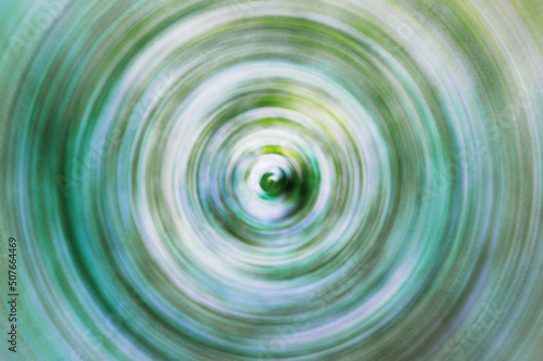 Colorful radial defocused textured background white green.