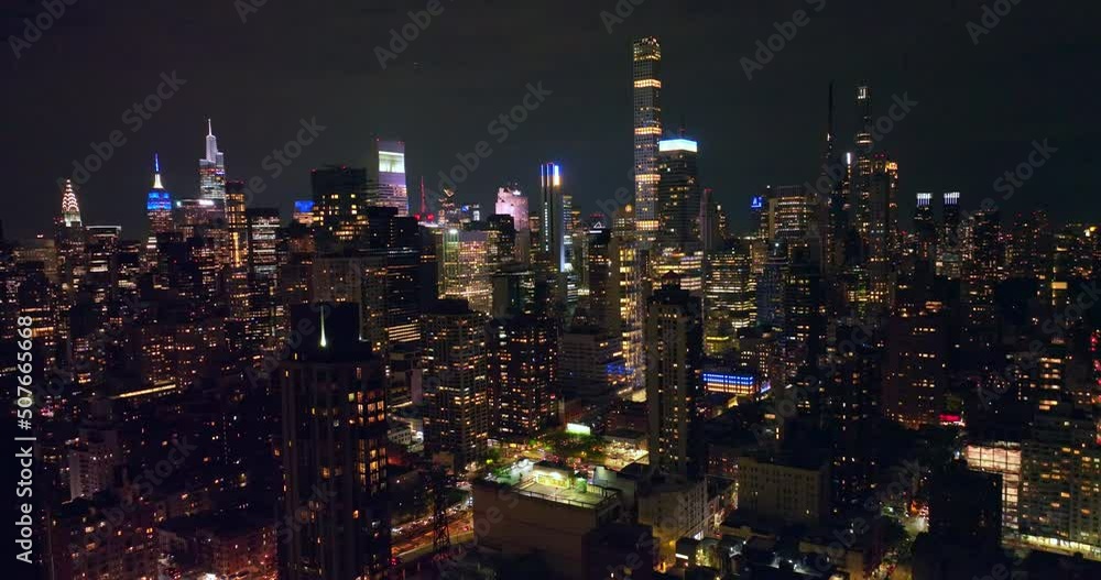 Fascinating panorama of New York at night. Calm and magnificent skyscrapers towering over busy streets with lively traffic. Fascinating panorama of New York at night. Calm and magnificent skyscrapers towering over busy streets with lively traffic.