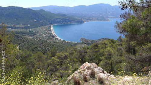 Psatha beach as seen from distance with clear calm sea, West Attica, Greece photo