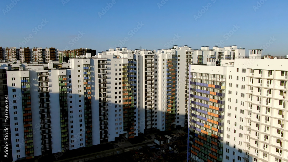 Top view of new residences on a Sunny day. Motion. Panoramic view on new quarter high-rise building area urban development residential quarter in sunny day from a bird's eye view