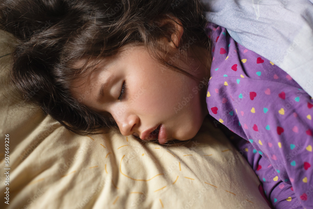 Obraz premium Healthy sleep of a little girl, time before waking up