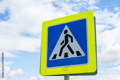 Road sign. Pedestrian crossing sign on blue sky background