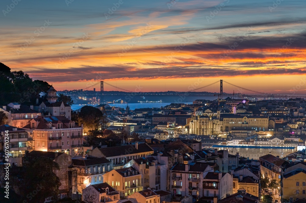 Sunset view of Bridge of 25th April and National sanctuary of Cristo Rei in Lisbon, Portugal