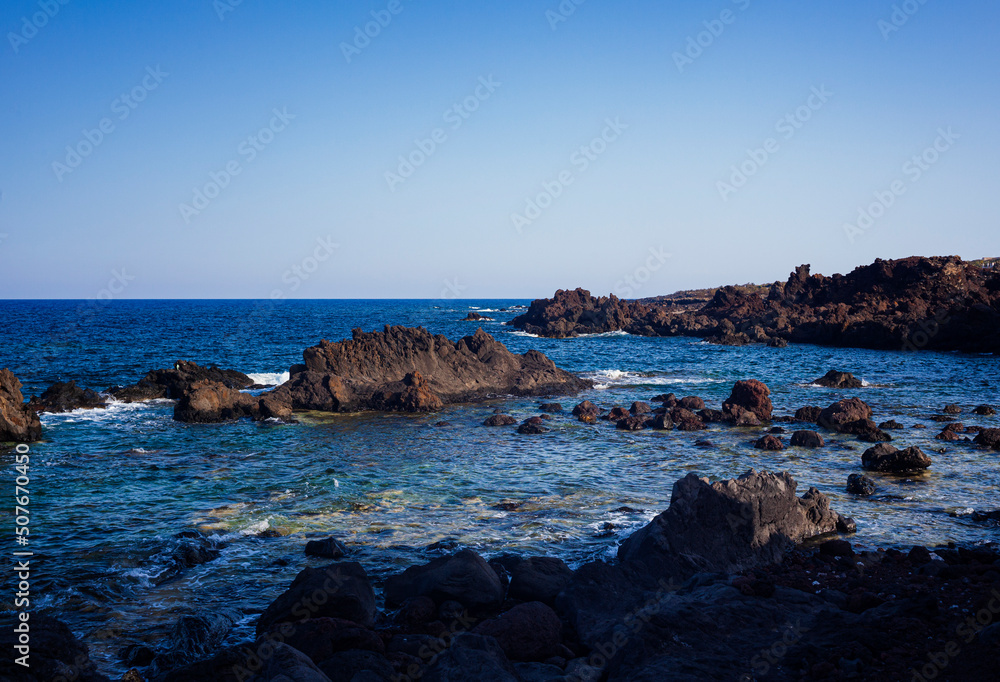 View of the lava beach of Linosa Called Faraglioni View of the lava beach of Linosa Called Faraglioni