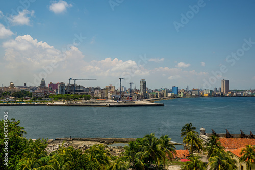 The skyline of Havana with a view of sea waves crashing against the Malecon wall