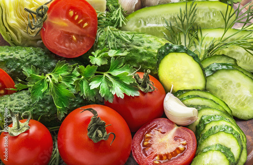 Background from vegetables. Fresh organic vegetables tomatoes, onions, cucumbers and greens.