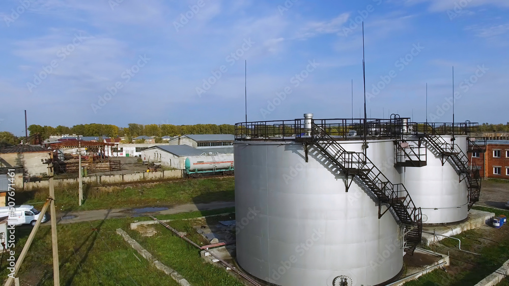 Aerial view white fuel storage tank in oil refinery plant. Stock. Top
