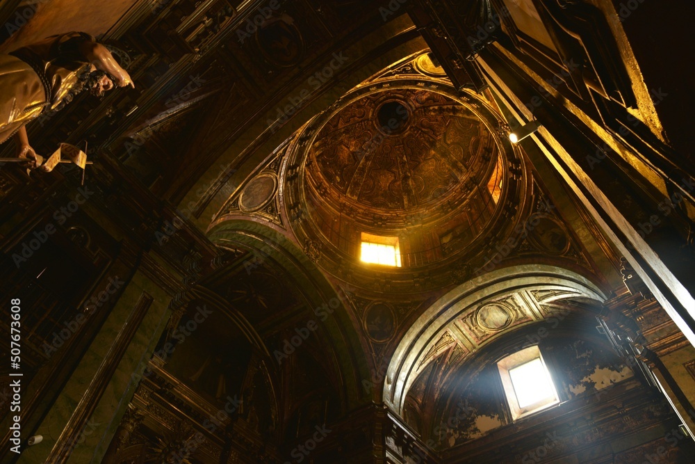 Obraz premium Rays of light flooding the golden Baroque splendor of the dome and arches of Basílica del Carmen church, Jerez de la Frontera, Spain
