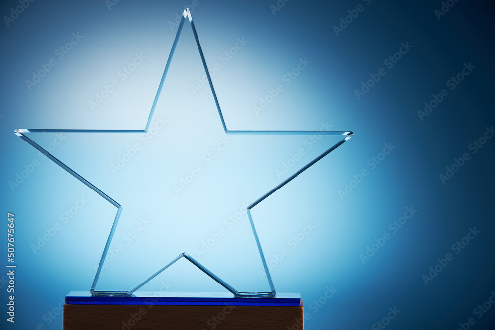 crystal star shape trophy against blue background crystal star shape trophy against blue background