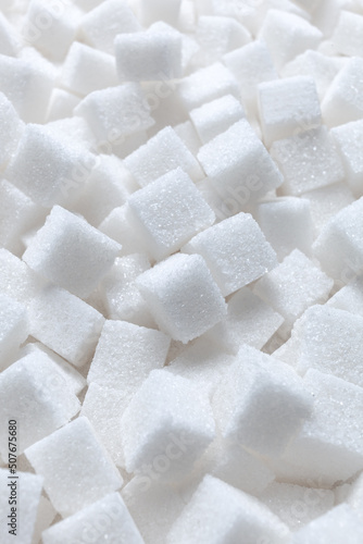 Rafinated sugar. Textured white background from sugar cubes.