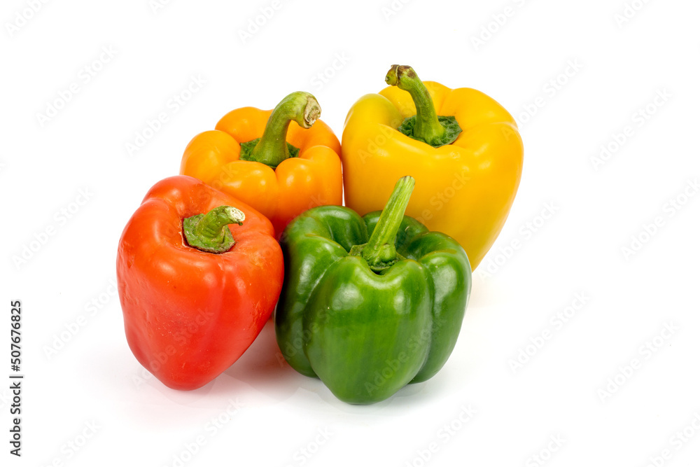 Capsicum - Bell Pepper green, red, orange, yellow isolated in plain extendable background, macro detailing, studio lighting, with ample copy space all around. Capsicum - Bell Pepper green, red, orange, yellow isolated in plain extendable background, macro detailing, studio lighting, with ample copy space all around.