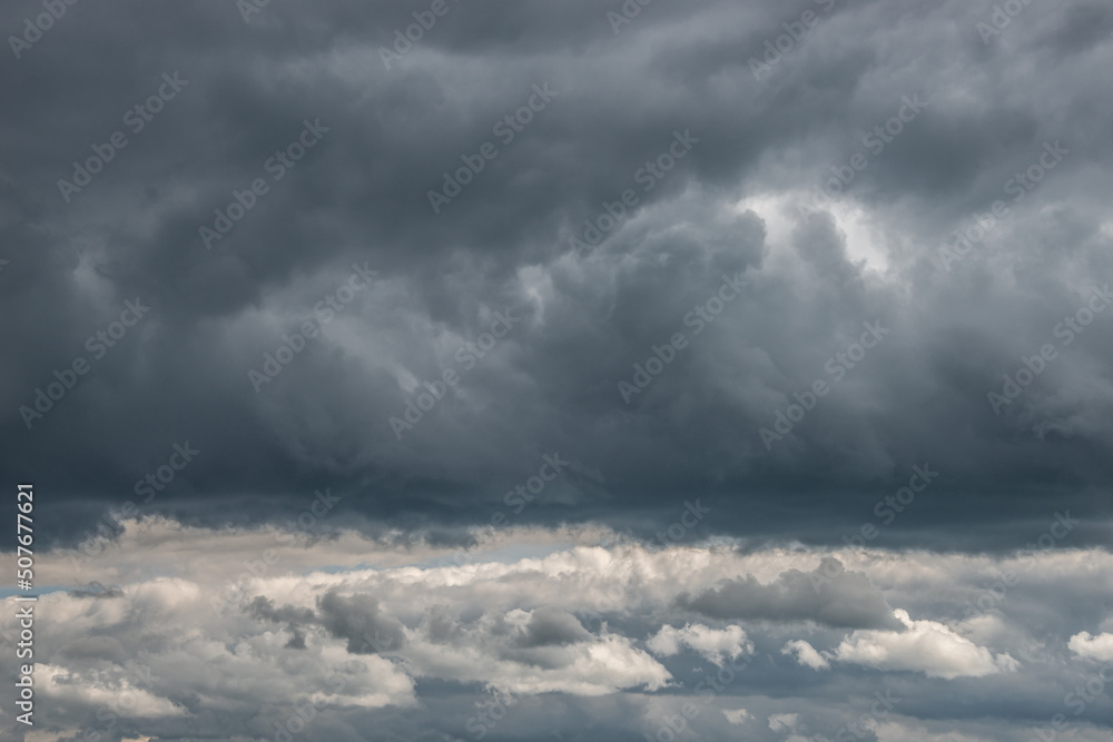 Dramatic rainy and stormy sky with heavy clouds as a background.
