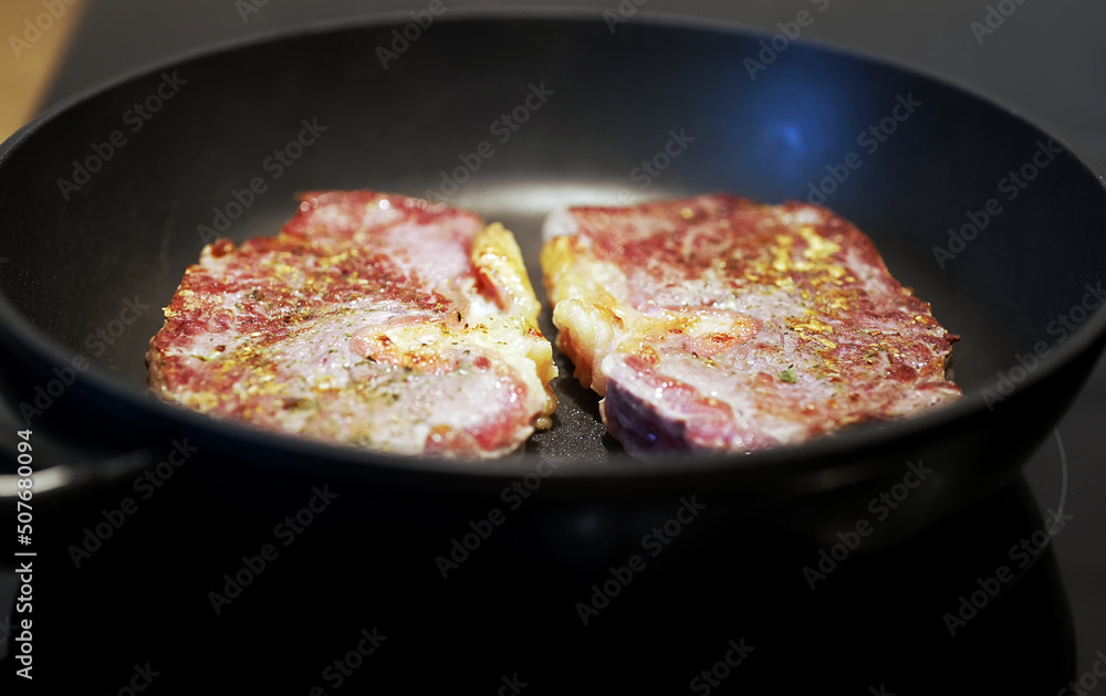 Juicy beef tenderloin is cooked in a skillet. Juicy beef tenderloin is cooked in a skillet.