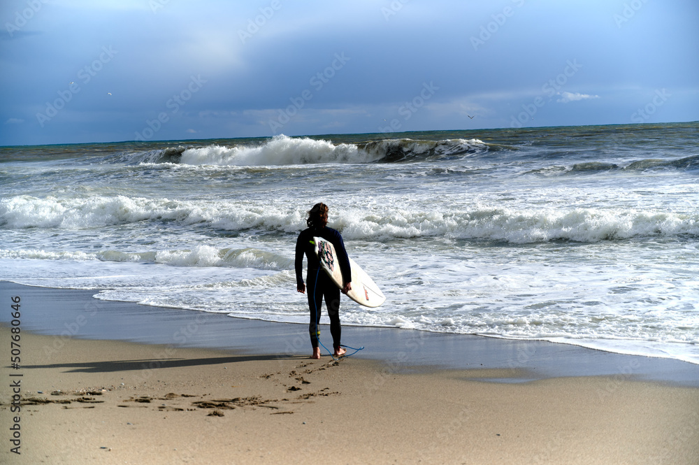 Windsurfer waiting for a good wave by the sea Windsurfer waiting for a good wave by the sea