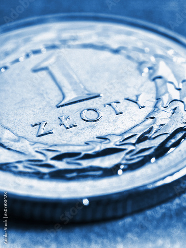 Translation: 1 zloty. Fragment of Polish one zloty coin close-up. National currency of Poland. Blue tinted vertical illustration for news about economy or finance. Macro