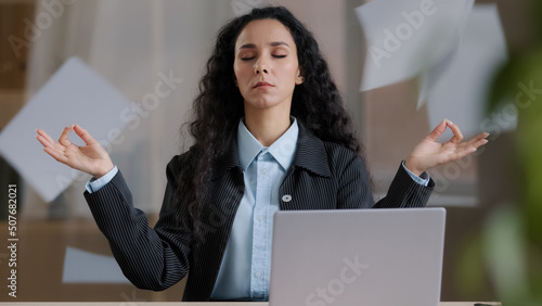 Canvas Print Calm mindful female business woman boss in lotus position taking break meditatin