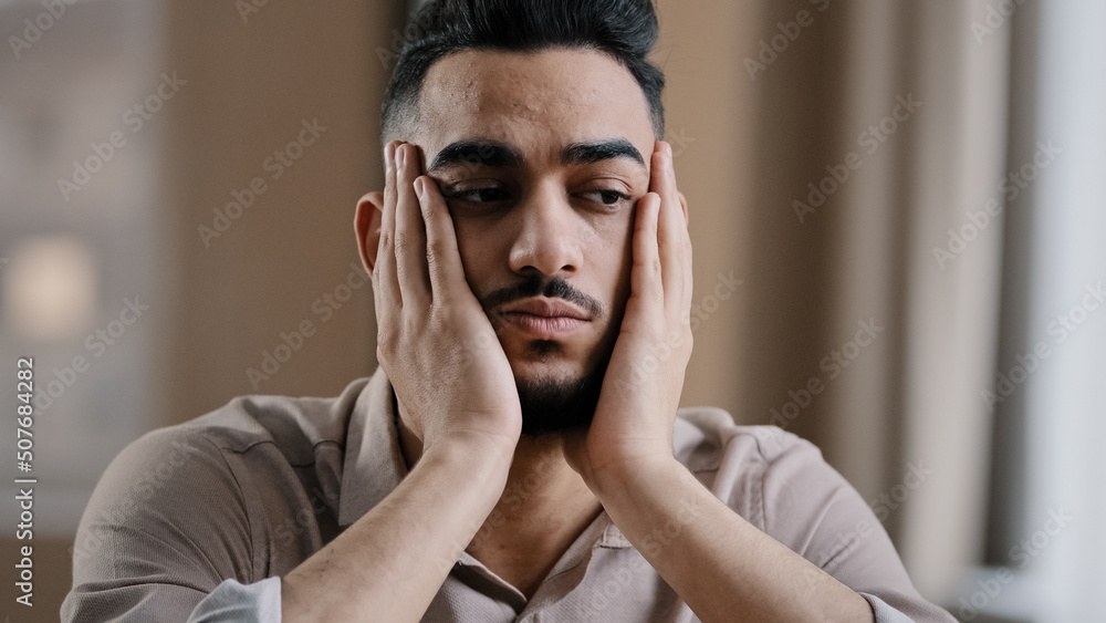 Depressed tired hispanic arab man guy businessman worker sit at home feel boredom depression massaging face forehead suffering from insomnia thinking about problem has burnout syndrome lack motivation Depressed tired hispanic arab man guy businessman worker sit at home feel boredom depression massaging face forehead suffering from insomnia thinking about problem has burnout syndrome lack motivation