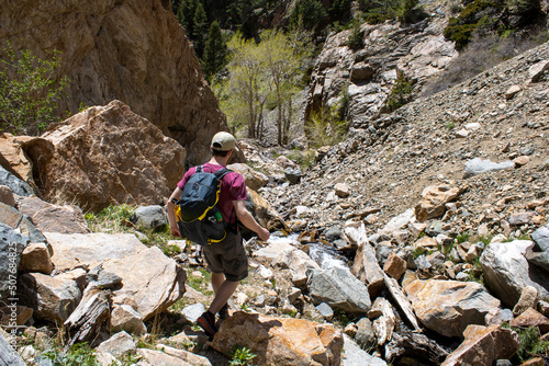 Man Hiking Rocky Terrain at Bridal Veil Falls Trail in Northern Wyoming in Shoshone National Forest photo