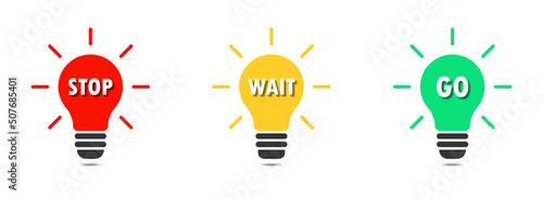 Stop, wait, and go color icons. Green Yellow and Red light bulbs with lettering. Flat vector illustration.