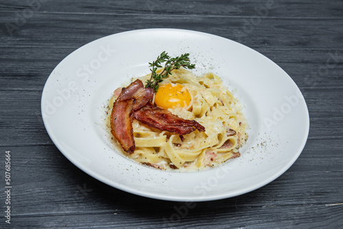 carbonara pasta on a gray wooden background