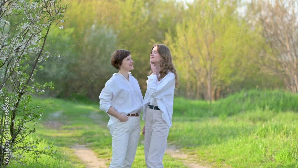 Happy family. Loving tender mum hugging with a cute daughter on a field at sunset. Mommy and Kid outdoor together. Happy family. Loving tender mum hugging with a cute daughter on a field at sunset. Mommy and Kid outdoor together.