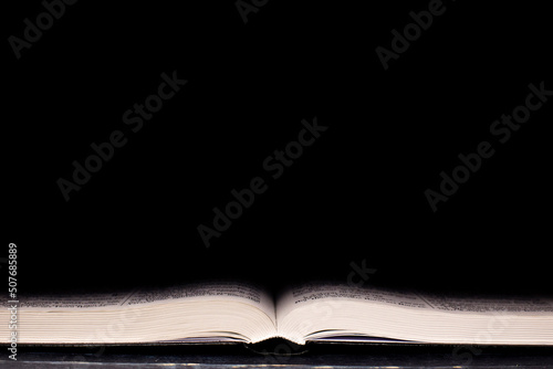 Canvastavla Open Bible. On a black background. Holy book.
