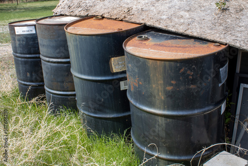 Old Metal Oil Barrels Rusting beside Shed in Wyoming