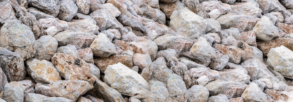 Rocky wall background texture. Close up view of stonewall, grey brown structure for backdrop. Banner Rocky wall background texture. Close up view of stonewall, grey brown structure for backdrop. Banner