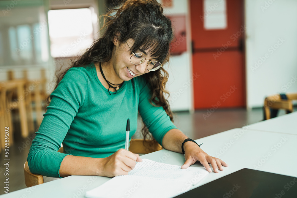 Young woman learing inside library at university school Young woman learing inside library at university school