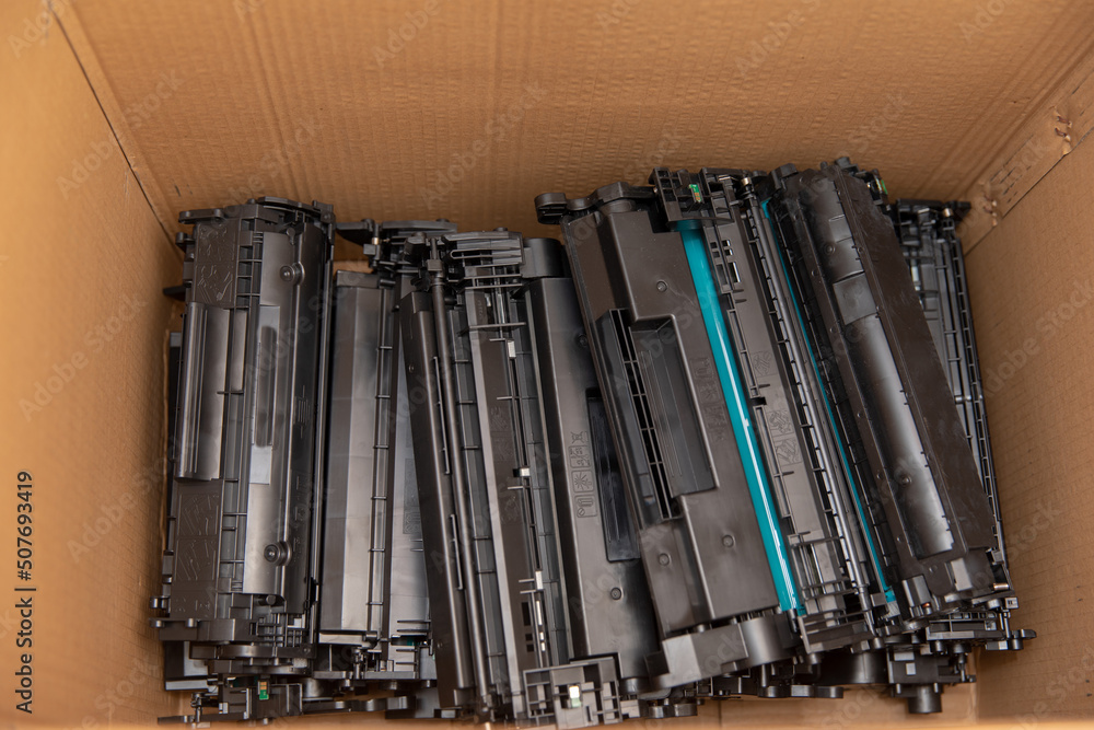 Collecting laser cartridges from laser printers for recycling.