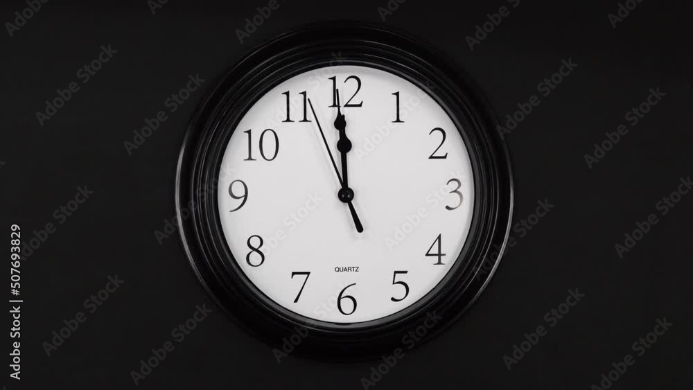 Classic Black And White Wall Clock With Black Background. Black Hands On The Clock. Wall Clock Face Of Time Of 12.00 Am Or Pm. 4k. ProRes.