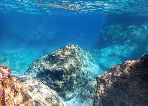 A tropical reef below the surface of the clear, transparent sea. Underwater scene.