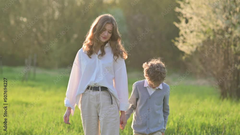 Lovely Children walk in the park holding hands on a sunny day. happy childhood concept. Childhood moment. Lovely Children walk in the park holding hands on a sunny day. happy childhood concept. Childhood moment.