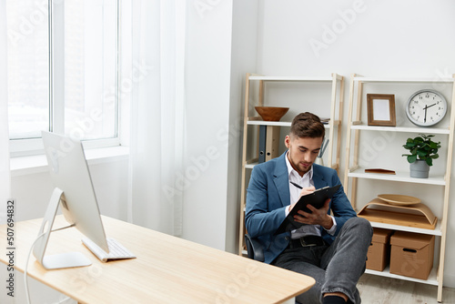 handsome businessman computer desktop work self-confidence paper folder executive