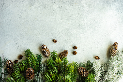 Overhead view of pinecones and fir branches on a table photo