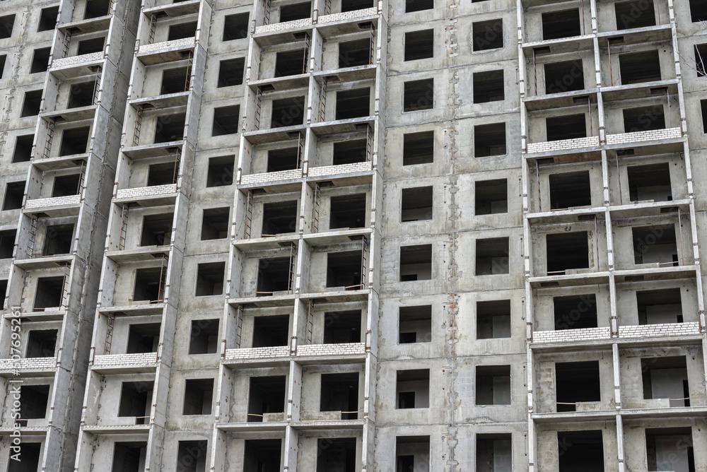 Construction of a residential building. Tower cranes building a new residential building. Unfinished panel house and construction crane Construction of a residential building. Tower cranes building a new residential building. Unfinished panel house and construction crane