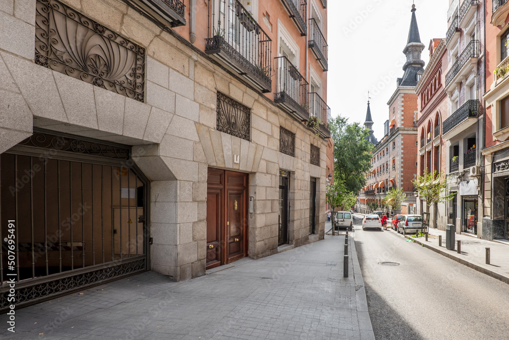 Central street in the city of Madrid with old buildings with large towers on the roofs
