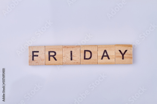 Friday word written on handmade wooden cubes against white background. Weekday concept.