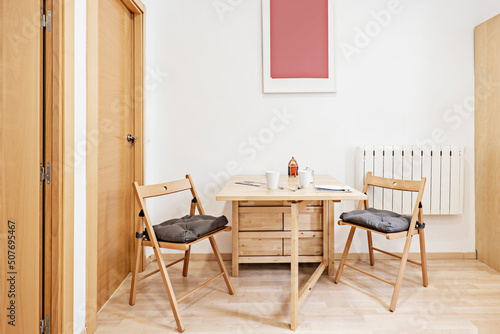 Folding wooden dining table with matching chairs © Toyakisfoto.photos