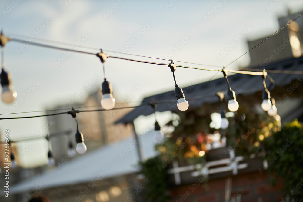 garland of lamps on a blurred background, at sunset, selective focus garland of lamps on a blurred background, at sunset, selective focus