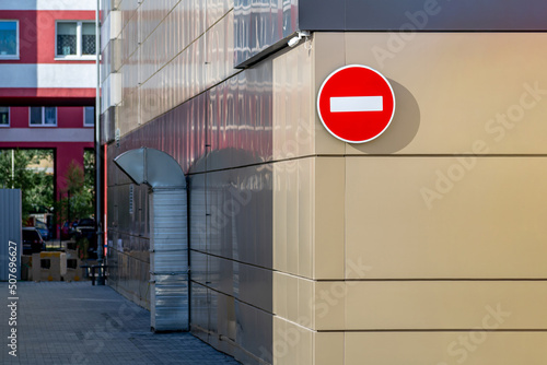 The road sign do not enter is placed on the facade of the building before entering the courtyard.