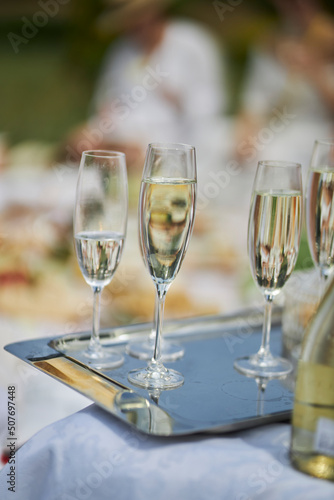 Champagne on a metal tray. Champagne at a picnic 