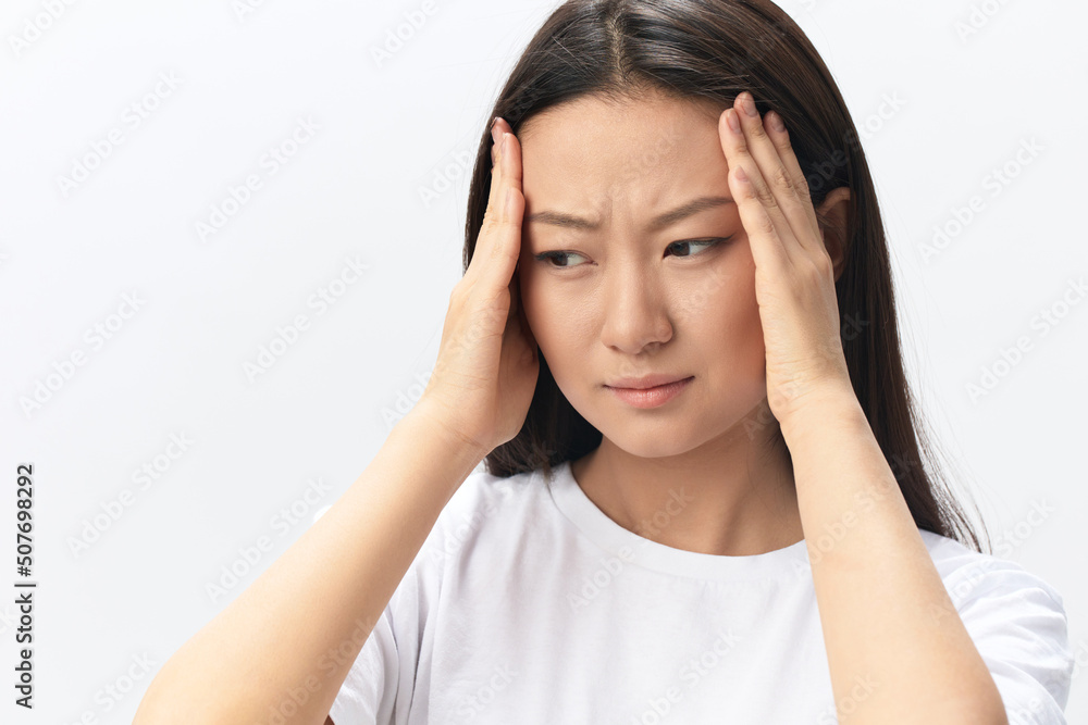 SARS CoVID symptoms. Tormented tanned beautiful young Asian lady touch forehead feel elevated temperatures posing isolated on white background. Injuries Poor health Illness concept. Cool offer Banner SARS CoVID symptoms. Tormented tanned beautiful young Asian lady touch forehead feel elevated temperatures posing isolated on white background. Injuries Poor health Illness concept. Cool offer Banner