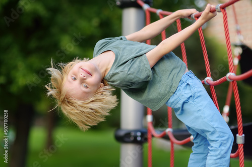 Εκτύπωση καμβά Cute perky preschooler boy having fun on outdoor playground