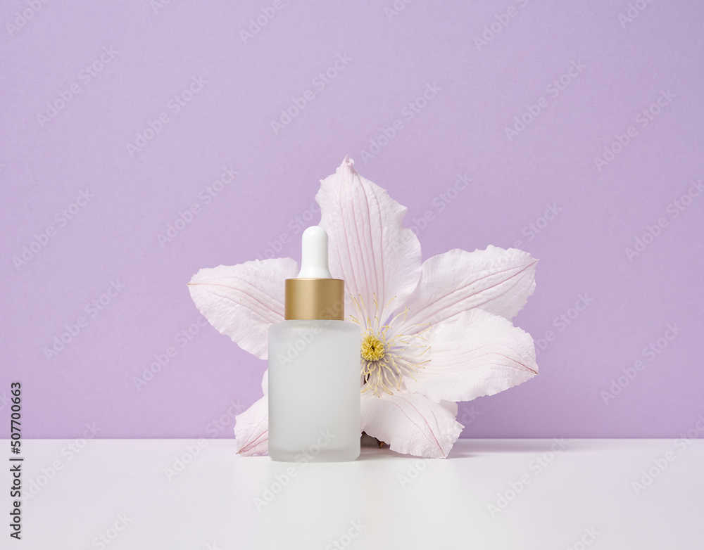 White glass bottle with pipette for cosmetics, oils and serum. Advertising and product promotion